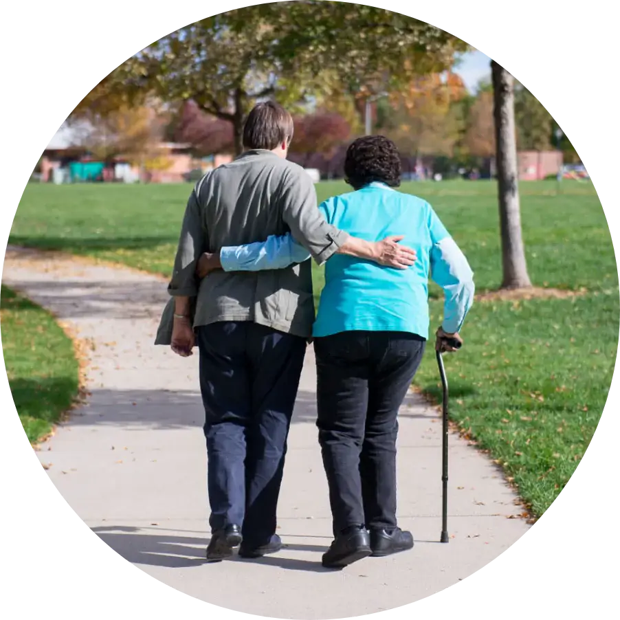 A photograph of a Cultivate volunteer walking with a client